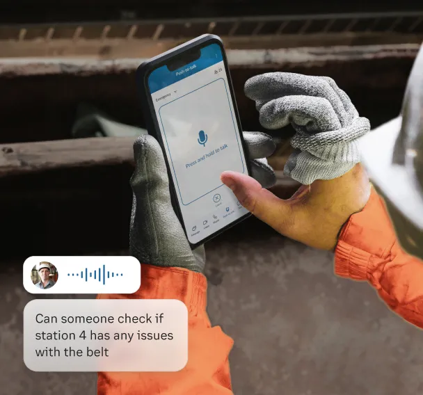 A worker uses the Push to Talk feature of the RingCentral app on a mobile phone