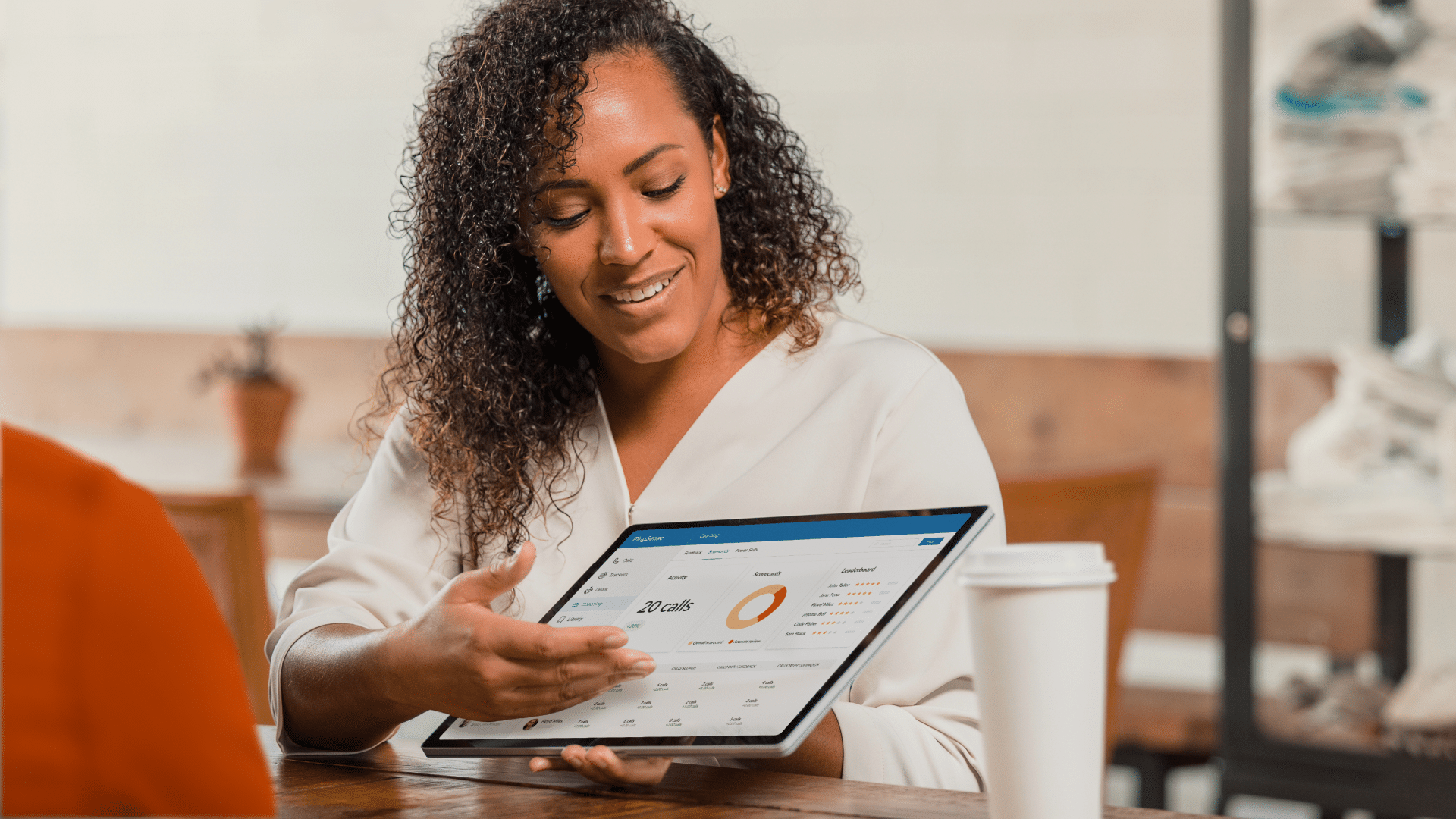 A contact center supervisor discussing a coaching dashboard that details call volume and performance analytics.