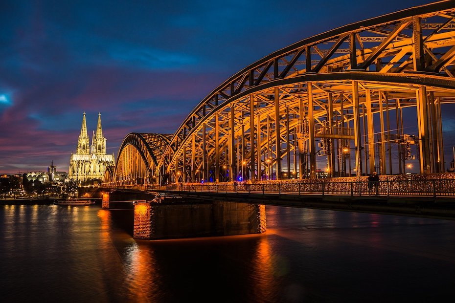 A bridge over a river at night.