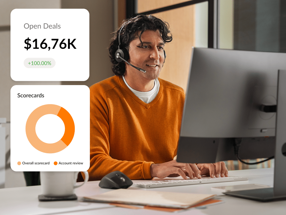 A man with headphones works on a computer displaying overlapping graphics of deals and scorecard metrics.