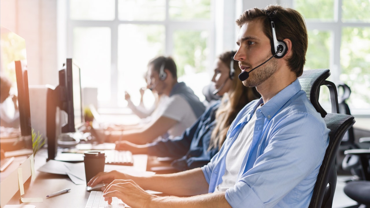 Man working on computer as a customer service rep